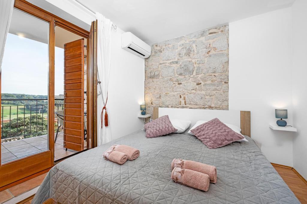 Bedroom with balcony access at Villa Vrsar